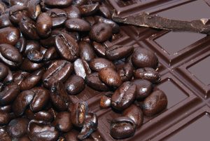 A bunch of coffee beans on top of chocolate