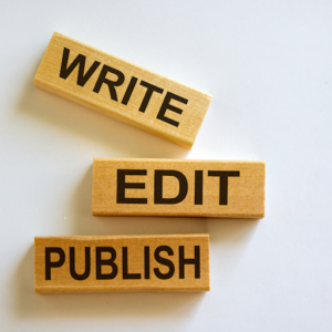 Three wooden blocks on a white background display the words "WRITE," "EDIT," and "PUBLISH" in bold black letters.